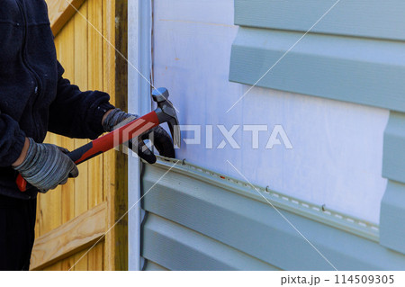 Replacing plastic siding on an exterior wall of residence house Replacing plastic siding on an exterior wall of residence house 114509305