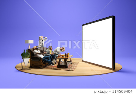 Losing game. Emotional men sitting on couch at home, with beer and snacks, emotionally watching online match translation on 3D TV screen 114509404