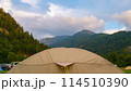 camping and tent with drops of night rain at dawn against the backdrop of the Austrian mountains 114510390