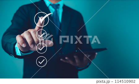 Businessman uses tablet to checklist and filling survey form online. Document management system, DMS. Quality control and accuracy Check. 114510902