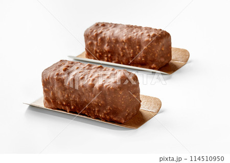 Two nuts and chocolate covered ice cream bars on white Two nuts and chocolate covered ice cream bars on white 114510950