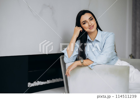 Business lady sitting in the chair in office hall. Portrait of beautiful woman  114511239
