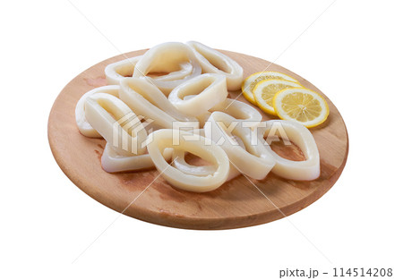 Raw squid rings ready for cooking on a cutting board isolated on a white background. Raw squid rings ready for cooking on a cutting board isolated on a white background. 114514208