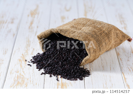 raw black rice in sack on a light table, selective focus. raw black rice in sack on a light table, selective focus. 114514257