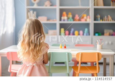 A young girl with long blonde hair stays by a colorful desk in a playfully decorated classroom, creating a vibrant, inviting educational environment. Generative AI. 114514557