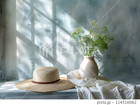 Straw Hat and White Vase under Sunlight in a Serene Room Setting 114516062