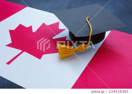 Canada flag and graduation cap on it. 114516361