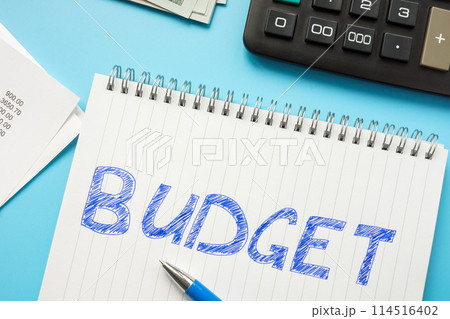 Handwritten inscription budget in a notepad next to the calculator. Handwritten inscription budget in a notepad next to the calculator. 114516402