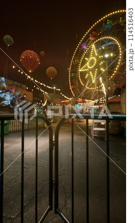 Ferris Wheel Illuminates Abandoned Amusement Park at Night 114516403