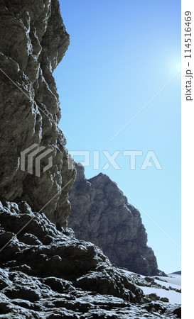 Rocky Outcrop in Sunlit Desert Terrain 114516469