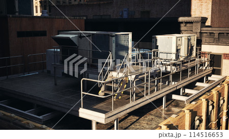 A rooftop view of a building with a roof mounted air conditioner 114516653