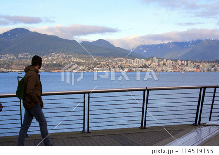 A person looking at north Vancouver from downtown seawall 114519155