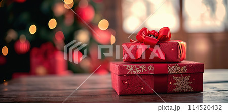 Christmas red gift boxes with a bow on a festive background 114520432