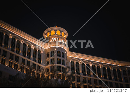 Bellagio Hotel and Casino on the Las Vegas Strip captured at night. Neoclassical architecture with illuminated tower and dome. Majestic and inviting appearance. 114521347