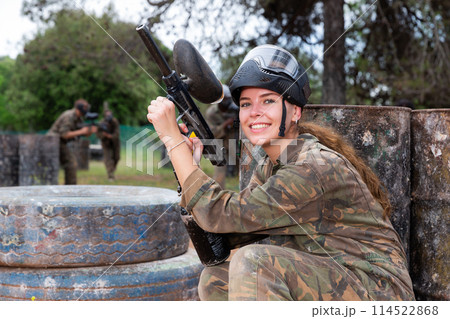 Portrait of girl in camouflage on paintball field Portrait of girl in camouflage on paintball field 114522868