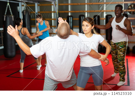 Woman exercising palm strike to chin during self-defence training Woman exercising palm strike to chin during self-defence training 114523310