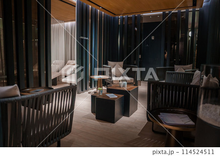 Luxury hotel room in Zermatt, Switzerland with modern design, plush furniture, dim lighting, and cozy ambiance. Chic and inviting space for relaxation. 114524511