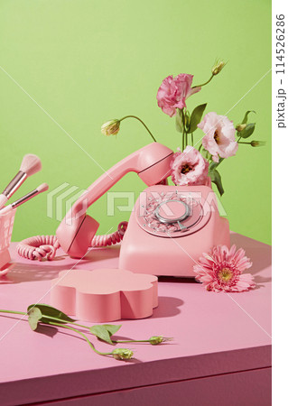 Template for designing with flower theme, an empty podium in flower shaped placed in center, decorated by some eustoma flower of pink and white color. Space for showing product has natural ingredient 114526286