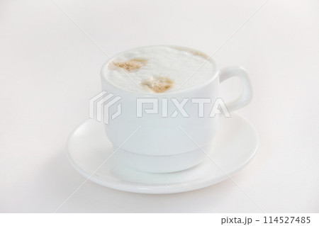 Closeup image of hot cup of coffee with milk isolated at white background. Closeup image of hot cup of coffee with milk isolated at white background. 114527485