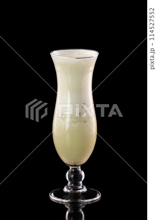 Glass of fresh melon milkshake isolated at black background. 114527552