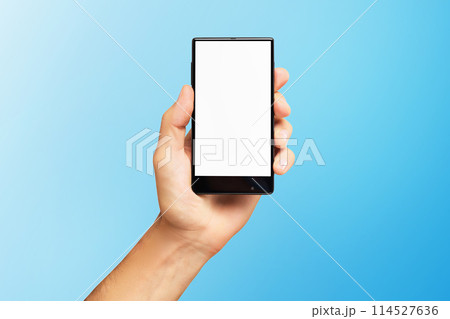 Mockup of male hand holding black frameless cell phone with blank screen isolated at blue background. Mockup of male hand holding black frameless cell phone with blank screen isolated at blue background. 114527636