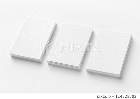 Mockup of three business cards stacks row at white textured paper background. 114528382