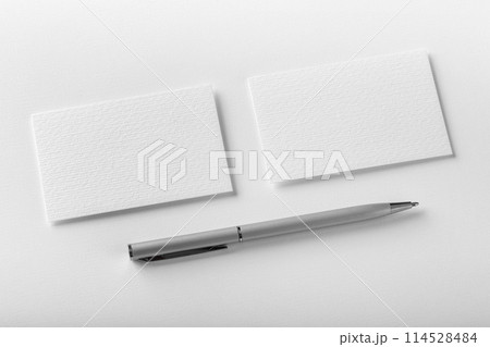 Mockup of two horizontal business cards and pen at white textured background. 114528484