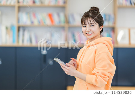 スマホを操作する大学生。 114529826