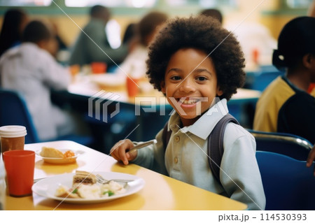 A schoolchild in the school cafeteria. Time of lunch break, peculiarities of the school meal, snack A schoolchild in the school cafeteria. Time of lunch break, peculiarities of the school meal, snack 114530393