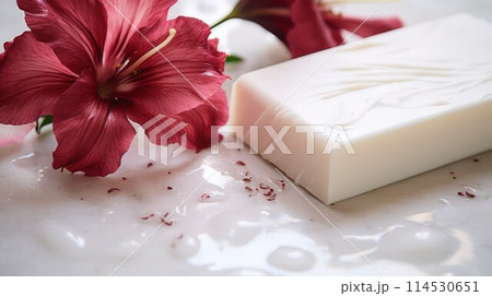 White natural soap with red flower on a milky white wet surface, close-up, selective focus. 114530651