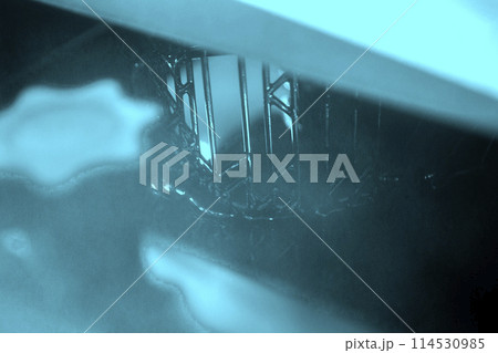 Working of photopolymer sla 3D printer. Platform with building object lowered into liquid photopolymer resins and hardened under ultraviolet laser. Progressive additive technology. 3D printer printing 114530985