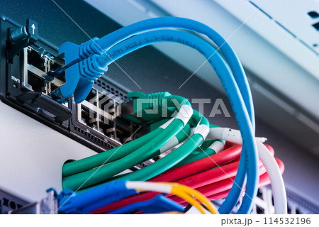 fiber optic cables connected to optic ports, network cables connected to ethernet ports fiber optic cables connected to optic ports, network cables connected to ethernet ports 114532196