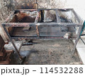 The iron table that houses the trader's stove looks dirty, the table has been used for annual trading 114532288