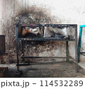 The iron table that houses the trader's stove looks dirty, the table has been used for annual trading 114532289