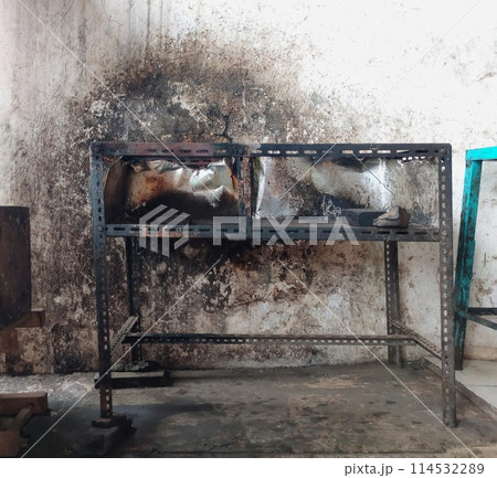 The iron table that houses the trader's stove looks dirty, the table has been used for annual trading The iron table that houses the trader's stove looks dirty, the table has been used for annual trading 114532289