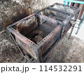 The iron table that houses the trader's stove looks dirty, the table has been used for annual trading 114532291