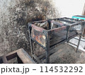 The iron table that houses the trader's stove looks dirty, the table has been used for annual trading 114532292