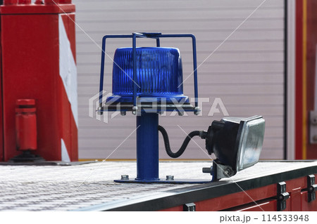 Flashing beacon of blue color and spotlight for lighting in the dark Flashing beacon of blue color and spotlight for lighting in the dark 114533948