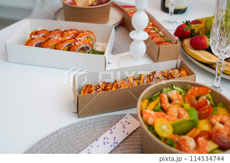 Sushi, friends and restaurant cheers with champagne for birthday celebration or social event. Celebrate toast, happy and smile of women with japanese food eating and drinking together with alcohol 114534744