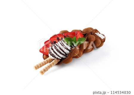 Hong kong or bubble waffle with ice cream, fruits, chocolate sauce and colorful candy isolated on white background Hong kong or bubble waffle with ice cream, fruits, chocolate sauce and colorful candy isolated on white background 114534830