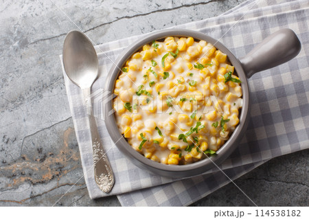 Homemade Slow Cooker Creamed Corn in a Bowl closeup on the bowl. Horizontal top view 114538182