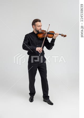 Bearded man violinist performing on concert Bearded man violinist performing on concert 114538639