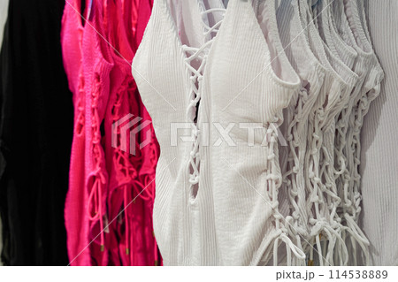 Women's swimsuit in the store. Fashionable swimsuits in white and pink colors 114538889