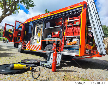 Fire truck with open doors on a sunny day. Fire truck with open doors on a sunny day. 114540314