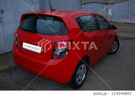 Beautiful red car.Red hatchback, rear view. Comfortable, roomy city car. Beautiful red car.Red hatchback, rear view. Comfortable, roomy city car. 114540665