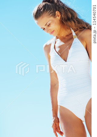 relaxed young woman in swimsuit on beach 114540701
