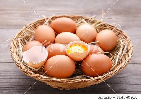 Fresh Chicken eggs in basket on grey wooden background 114540918
