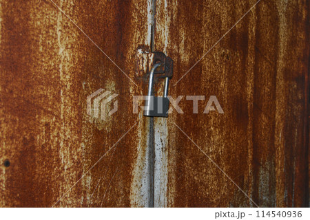 Medium gray lock on the gate.Compact padlock, medium size.One object. 114540936