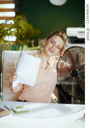 happy 40 years old accountant woman in green office 114540974