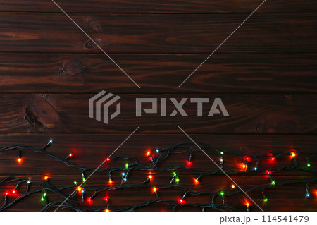 Christmas garland lights on brown background, copy space Christmas garland lights on brown background, copy space 114541479